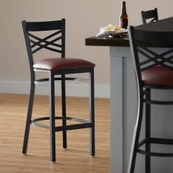 Lancaster Table & Seating Black Finish Cross Back Bar Stool With 2 1/2" Burgundy Vinyl Padded Seat