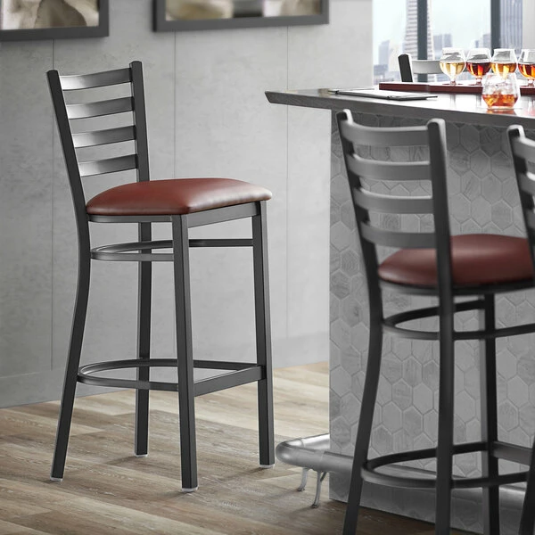 Lancaster Table & Seating Black Finish Ladder Back Bar Stool With 2 1/2" Burgundy Vinyl Padded Seat 1 Lancaster Table & Seating Black Finish Ladder Back Bar Stool With 2 1/2" Burgundy Vinyl Padded Seat
