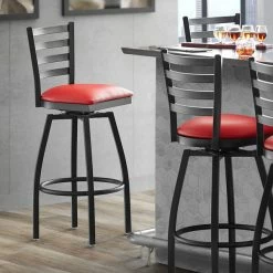 Lancaster Table & Seating Black Finish Ladder Back Swivel Bar Stool With 2 1/2" Red Vinyl Padded Seat