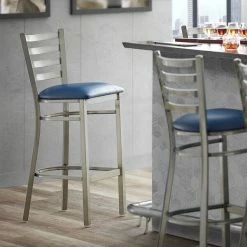 Lancaster Table & Seating Clear Coat Finish Ladder Back Bar Stool With 2 1/2" Navy Blue Vinyl Padded Seat