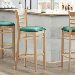 Lancaster Table & Seating Natural Ladder Back Bar Height Chair With 2 1/2" Green Padded Seat