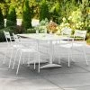 Lancaster Table & Seating 32" X 60" White Powder-Coated Aluminum Dining Height Outdoor Table With Umbrella Hole And 4 Arm Chairs
