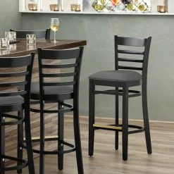 Lancaster Table & Seating Black Finish Wooden Ladder Back Bar Height Chair With Dark Gray Padded Seat