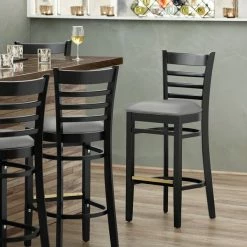 Lancaster Table & Seating Black Finish Wooden Ladder Back Bar Height Chair With Light Gray Padded Seat