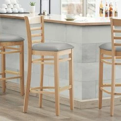 Lancaster Table & Seating Natural Finish Wooden Ladder Back Bar Height Chair With Light Gray Padded Seat