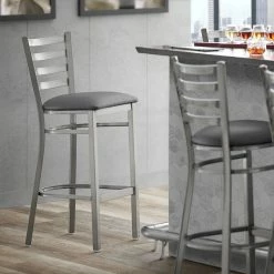 Lancaster Table & Seating Clear Coat Finish Ladder Back Bar Stool With 2 1/2" Dark Gray Vinyl Padded Seat