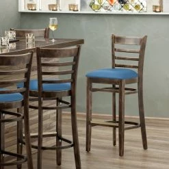 Lancaster Table & Seating Vintage Finish Wooden Ladder Back Bar Height Chair With Blue Padded Seat