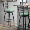 Lancaster Table & Seating Black Finish Ladder Back Swivel Bar Stool With 2 1/2" Seafoam Vinyl Padded Seat