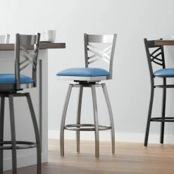 Lancaster Table & Seating Clear Coat Finish Cross Back Swivel Bar Stool With 2 1/2" Blue Vinyl Padded Seat