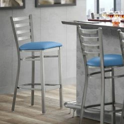 Lancaster Table & Seating Clear Coat Finish Ladder Back Bar Stool With 2 1/2" Blue Vinyl Padded Seat