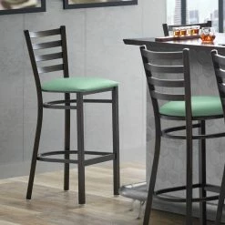 Lancaster Table & Seating Distressed Copper Finish Ladder Back Bar Stool With 2 1/2" Seafoam Vinyl Padded Seat