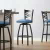 Lancaster Table & Seating Black Finish Cross Back Swivel Bar Stool With 2 1/2" Blue Vinyl Padded Seat