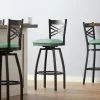 Lancaster Table & Seating Black Finish Cross Back Swivel Bar Stool With 2 1/2" Seafoam Vinyl Padded Seat