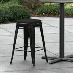 LT&S Alloy Series Lancaster Table & Seating Alloy Series Black Stackable Metal Indoor / Outdoor Industrial Cafe Counter Height Stool With Black Fabric Magnetic Cushion