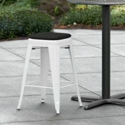 LT&S Alloy Series Lancaster Table & Seating Alloy Series White Stackable Metal Indoor / Outdoor Industrial Cafe Counter Height Stool With Black Fabric Magnetic Cushion