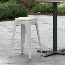 LT&S Alloy Series Lancaster Table & Seating Alloy Series Silver Stackable Metal Indoor / Outdoor Industrial Cafe Counter Height Stool With Tan Fabric Magnetic Cushion