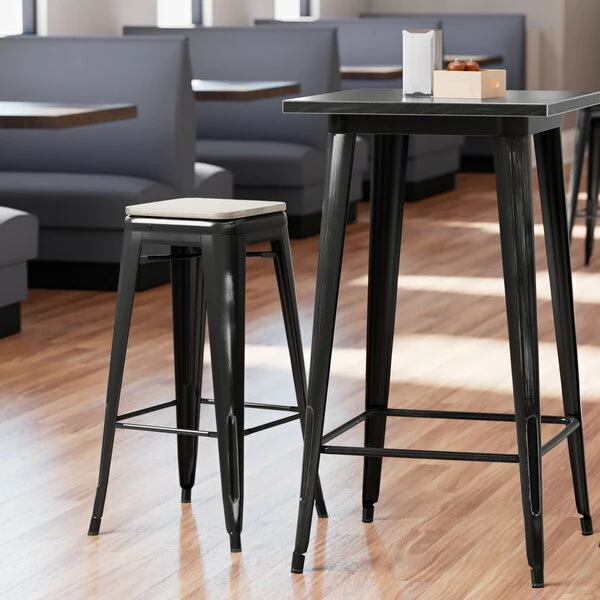 LT&S Alloy Series Lancaster Table & Seating Alloy Series Distressed Black Stackable Metal Indoor Industrial Barstool With Gray Wood Seat 1 LT&S Alloy Series Lancaster Table & Seating Alloy Series Distressed Black Stackable Metal Indoor Industrial Barstool With Gray Wood Seat