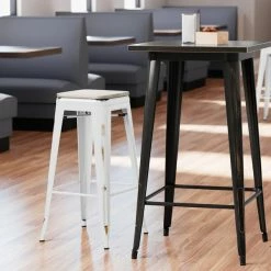 LT&S Alloy Series Lancaster Table & Seating Alloy Series Distressed White Stackable Metal Indoor Industrial Barstool With Gray Wood Seat