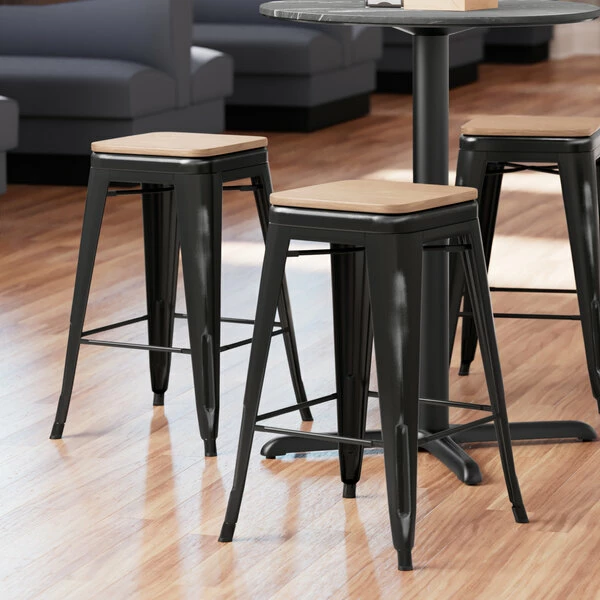 LT&S Alloy Series Lancaster Table & Seating Alloy Series Distressed Black Metal Indoor Industrial Cafe Counter Height Stool With Natural Wood Seat 1 LT&S Alloy Series Lancaster Table & Seating Alloy Series Distressed Black Metal Indoor Industrial Cafe Counter Height Stool With Natural Wood Seat