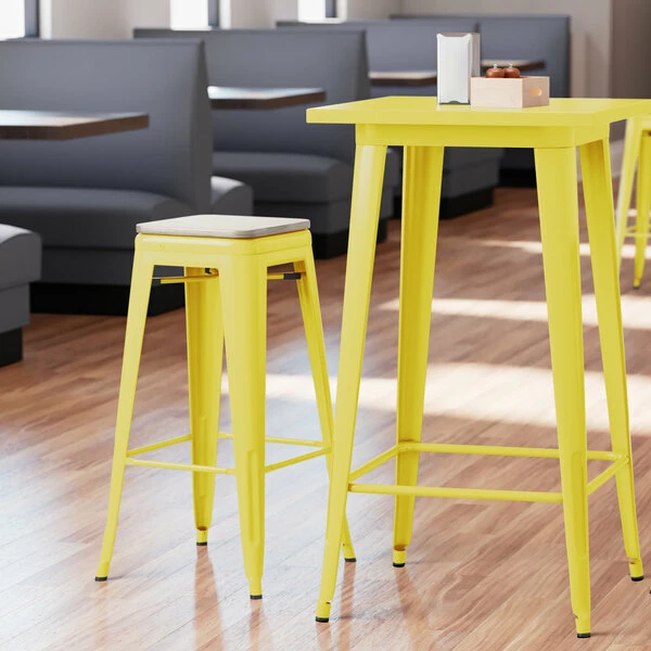 LT&S Alloy Series Lancaster Table & Seating Alloy Series Yellow Stackable Metal Indoor Industrial Barstool With Gray Wood Seat 1 LT&S Alloy Series Lancaster Table & Seating Alloy Series Yellow Stackable Metal Indoor Industrial Barstool With Gray Wood Seat