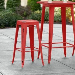 LT&S Alloy Series Lancaster Table & Seating Alloy Series Distressed Red Stackable Metal Indoor / Outdoor Industrial Barstool With Drain Hole Seat