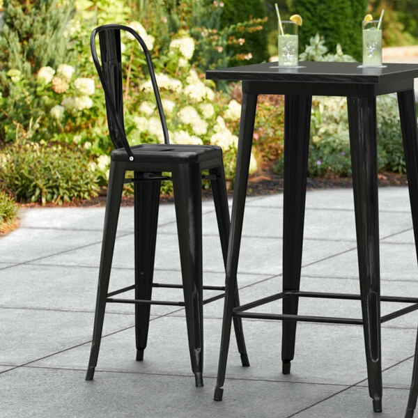 LT&S Alloy Series Lancaster Table & Seating Alloy Series Distressed Black Metal Indoor / Outdoor Industrial Cafe Barstool With Vertical Slat Back And Drain Hole Seat 1 LT&S Alloy Series Lancaster Table & Seating Alloy Series Distressed Black Metal Indoor / Outdoor Industrial Cafe Barstool With Vertical Slat Back And Drain Hole Seat