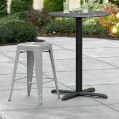 LT&S Alloy Series Lancaster Table & Seating Alloy Series Silver Stackable Metal Indoor / Outdoor Industrial Cafe Counter Height Stool With Drain Hole Seat