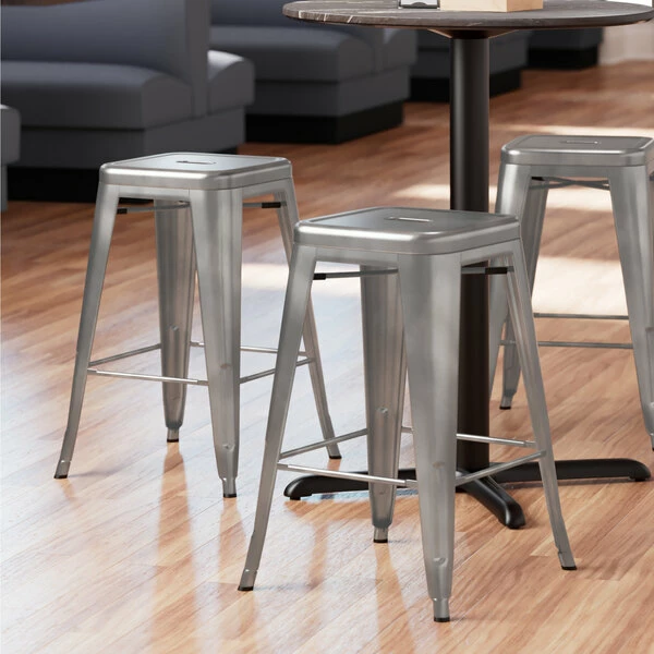 LT&S Alloy Series Lancaster Table & Seating Alloy Series Clear Coated Stackable Metal Indoor Industrial Cafe Counter Height Stool With Drain Hole Seat 1 LT&S Alloy Series Lancaster Table & Seating Alloy Series Clear Coated Stackable Metal Indoor Industrial Cafe Counter Height Stool With Drain Hole Seat