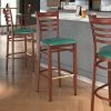 LT&S Spartan Series Lancaster Table & Seating Spartan Series Bar Height Metal Ladder Back Chair With Mahogany Wood Grain Finish And Green Vinyl Seat