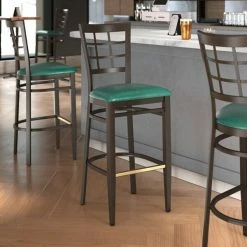 LT&S Spartan Series Lancaster Table & Seating Spartan Series Bar Height Metal Window Back Chair With Walnut Wood Grain Finish And Green Vinyl Seat
