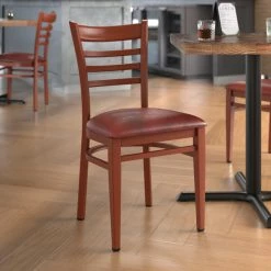 LT&S Spartan Series Lancaster Table & Seating Spartan Series Metal Ladder Back Chair With Mahogany Wood Grain Finish And Burgundy Vinyl Seat